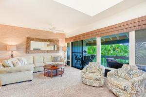 a living room with a couch and two chairs at Manualoha 608 in Koloa