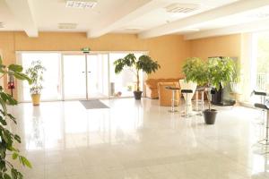 a lobby with potted plants in a building at Hotel Reuterhof in Darmstadt