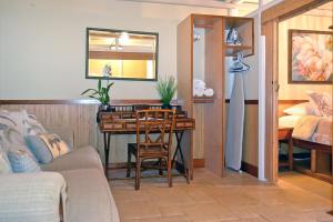 a living room with a table and a bed at Kuhio Shores 207 in Koloa