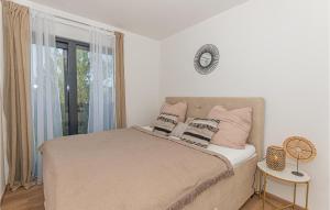 a bedroom with a bed with pink pillows and a window at Cozy Home In Srima With Wifi in Srima +35 photos