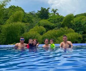 a group of people in a swimming pool at Finca Hotel Mirador Del Bambú in Alcalá