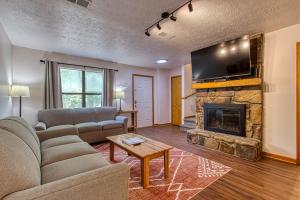 a living room with a couch and a fireplace at Pool-Pinecrest Townhomes-Full Building-14bed17bath in Pigeon Forge