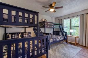 a bedroom with two bunk beds and a ceiling fan at Pool-Pinecrest Townhomes-Full Building-14bed17bath in Pigeon Forge