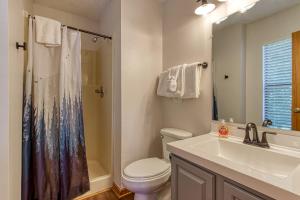 a bathroom with a toilet and a sink and a shower at Pool-Pinecrest Townhomes-Full Building-14bed17bath in Pigeon Forge