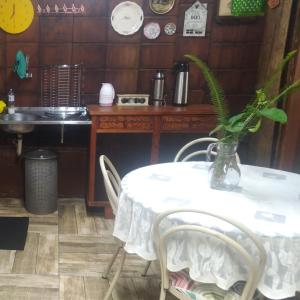 a table with a vase on it with a plant on it at Cabana Bambu in Sapiranga