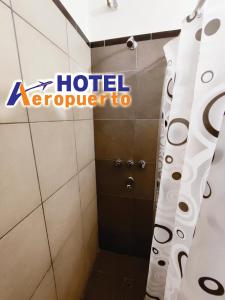 a hotel expedia sign in a bathroom with a shower at Hotel AEROPUERTO Jujuy in Perico