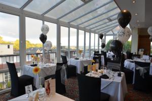 a dining room with tables and chairs with balloons at The Riviera Hotel & Apartments - Alum Chine in Bournemouth