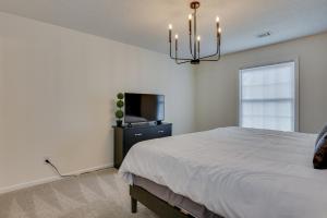 a bedroom with a bed and a flat screen tv at Serene Sanctuary Near I-20 in Augusta