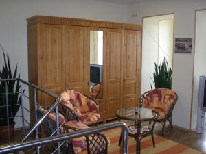 a living room with two chairs and a table at Viesu Nams Vecupe in Birzgale