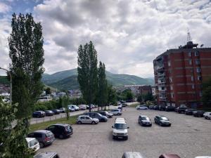 a parking lot full of cars in a city at Apartment 4 Kullat in Prizren