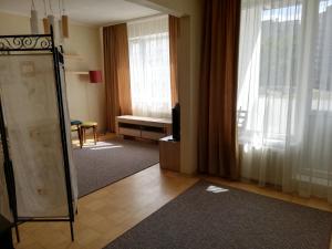 a living room with a television and a window at 15 minutes from the Beach and city Center 7 minutes from the airport in Rīga
