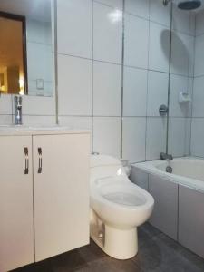 a bathroom with a toilet and a sink and a tub at casa hospedaje regina marie in Huaraz +12 photos