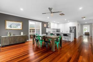 a kitchen and dining room with a table and chairs at Lady Nelson in Sorrento