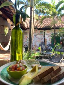 a plate of food with a bowl of fruit and a bottle at Cueva Nica in Granada