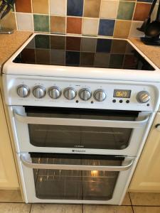 a white stove top oven sitting in a kitchen at The Burnham House in Bath