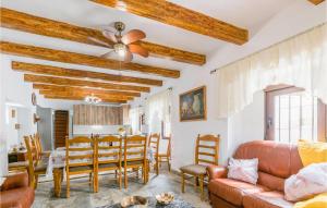 a living room with wooden ceilings and a table and chairs at 4 Bedroom Stunning Home In Villanueva De Algaidas in Villanueva de Algaidas