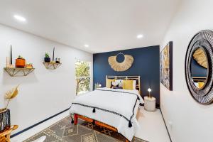 a bedroom with a bed and a blue wall at Unique Hideaway in Joshua Tree