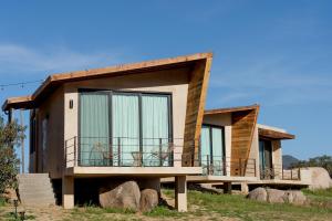 a house with a large balcony on the side of it at Paraje Hotel de Campo in Ensenada