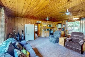 a living room with a couch and a refrigerator at The Cabin on the Lake in Worley