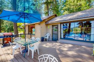 a patio with a table and chairs on a deck at The Cabin on the Lake in Worley