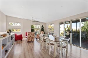 a kitchen and living room with a table and chairs at 45 Norman Drive in Cowes