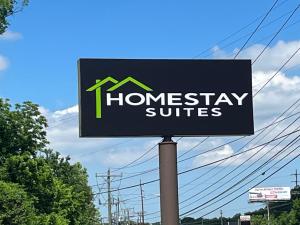 a sign for a homesteadery suites on a street at HomeStay Suites in Nashville