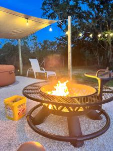a fire pit in the middle of a patio at Tropical glamping with hot tub in Cleveland