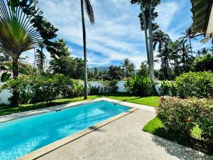 una piscina en un patio con palmeras en SAWAN Residence Pool Villas, en Lamai