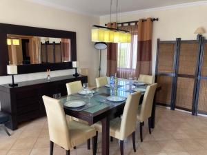 a dining room with a dining table and chairs at Casa dos Salgados in Albufeira