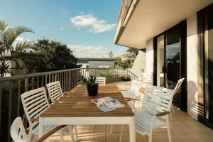 a wooden table and chairs on a balcony at The Rocks Resort Unit 2i in Gold Coast