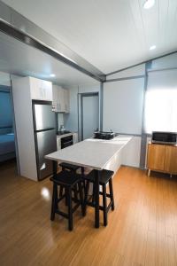 a kitchen with a table and chairs in a room at Norwesta Lifestyle Park in Carnarvon