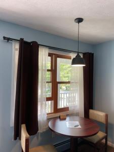 a dining room with a table and a window at M22 Inn Glen Arbor in Glen Arbor
