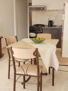 a kitchen with a table and chairs with a bowl on it at Luminoso dpto con wifi in San Luis