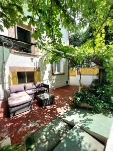 a couch sitting on a patio in a yard at N1 Casa de Madrid - greenpeace line in Madrid