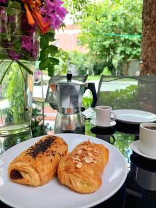 two pastries on a white plate on a table at N1 Casa de Madrid - greenpeace line in Madrid