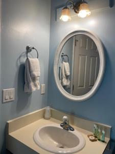 a bathroom with a sink and a mirror at M22 Inn Glen Arbor in Glen Arbor