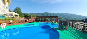 a swimming pool with a slide in a resort at Korea Quality Elf Hotel in Pyeongchang 
