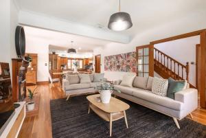 a living room with a couch and a table at Hahndorf Luxury Retreat in Hahndorf