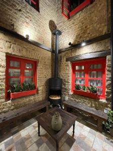 a brick wall with red windows and benches and a stove at QUINTA SEIS TRES in Bogotá