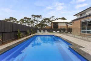 a swimming pool in the backyard of a house at Coastal Grand On McKenzie in Cowes