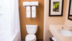 a bathroom with a toilet and a sink at Home 1 Suites Extended Stay in Montgomery +23 photos