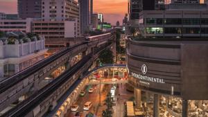 a view of a city at night with a train at InterContinental Bangkok by IHG in Bangkok