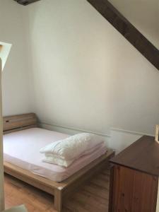 a bedroom with a bed and a wooden table at Beautiful Top Floor Apartment with Lake View in Lausanne
