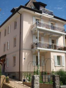 a large white building with a balcony at Beautiful Top Floor Apartment with Lake View in Lausanne