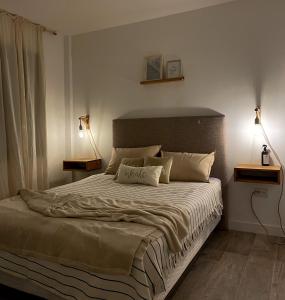 a bedroom with a large bed with two lamps at Ruca Malal in San Carlos de Bariloche