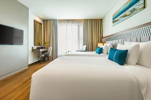 Voodi või voodid majutusasutuse Peninsula Hotel Danang toas