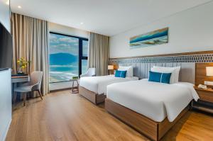 Voodi või voodid majutusasutuse Peninsula Hotel Danang toas