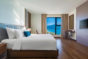 Voodi või voodid majutusasutuse Peninsula Hotel Danang toas