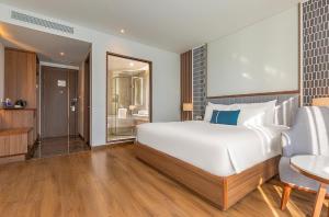 Voodi või voodid majutusasutuse Peninsula Hotel Danang toas