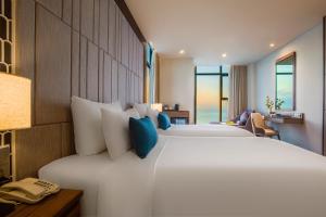 Voodi või voodid majutusasutuse Peninsula Hotel Danang toas